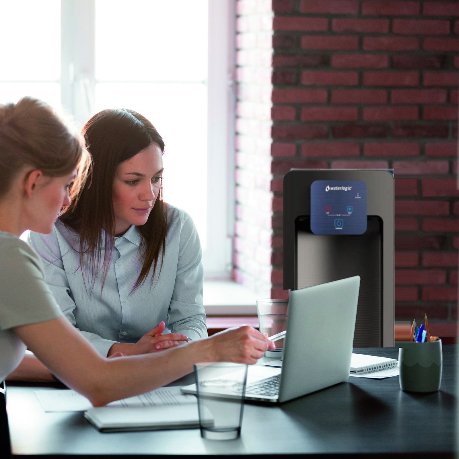 Waterlogic WL30 bottleless water cooler behind two coworkers in an office