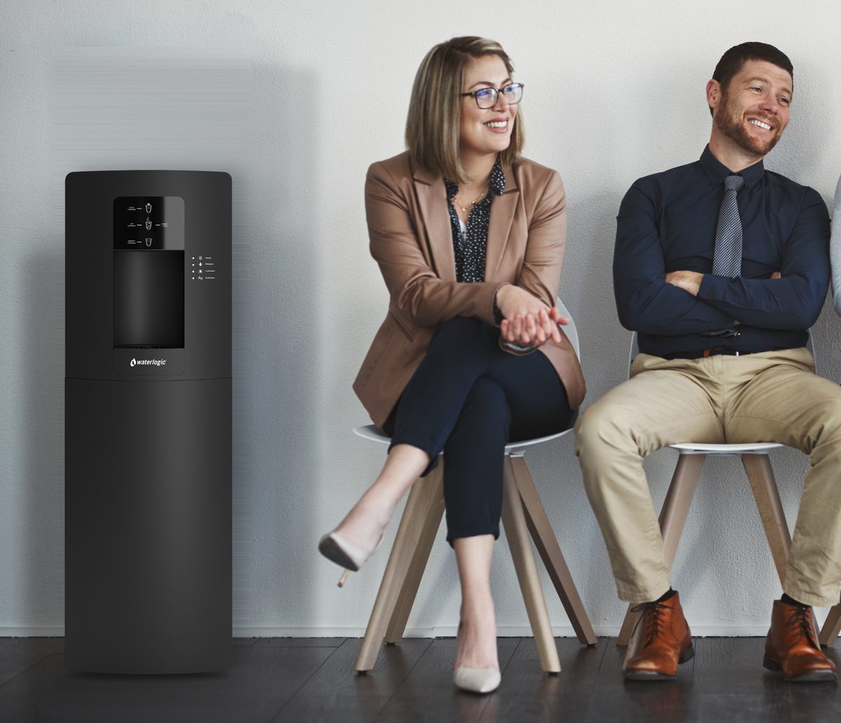 Office team seated next to a Waterlogic WL3 water dispenser tower